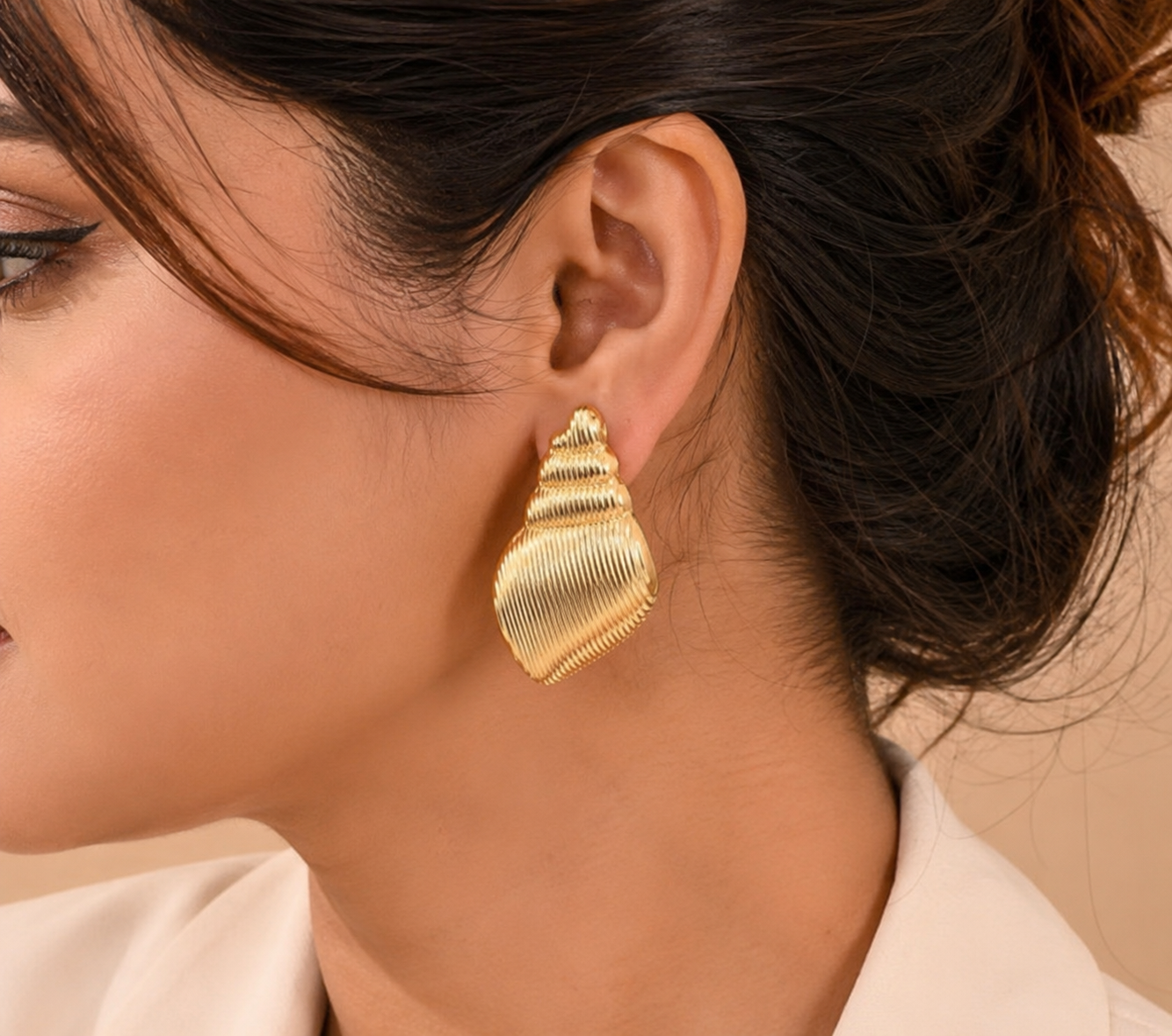 Second image of Gold Ribbed Conch Shell Stud Earrings