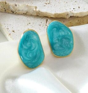 Marble Luxe Statement Stud Earrings feature a stunning marbled resin design framed with a sleek gold-tone border.