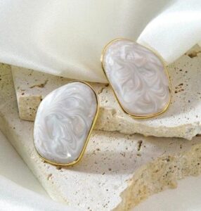 Marble Luxe Statement Stud Earrings feature a stunning marbled resin design framed with a sleek gold-tone border.
