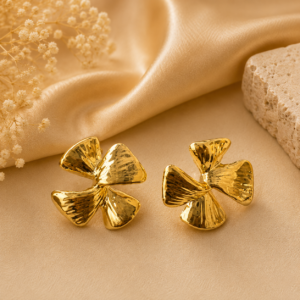 Pinwheel sculpted gold statement stud earrings with abstract floral design and polished gold finish.