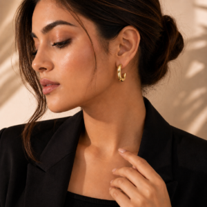 Chunky gold teardrop hoop earrings with a polished mirror finish and modern sculptural design.