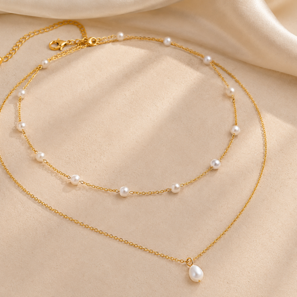 Gold-tone choker necklace featuring elegant pearl drop charms on a delicate chain