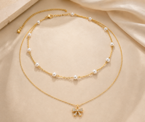 Gold-tone choker necklace with dangling white pearl charms
