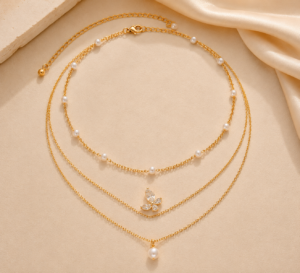 Gold-tone choker necklace with dangling white pearl drop charms