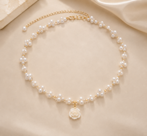 Layered gold-tone necklace featuring delicate pearl charms and elegant chain detailing