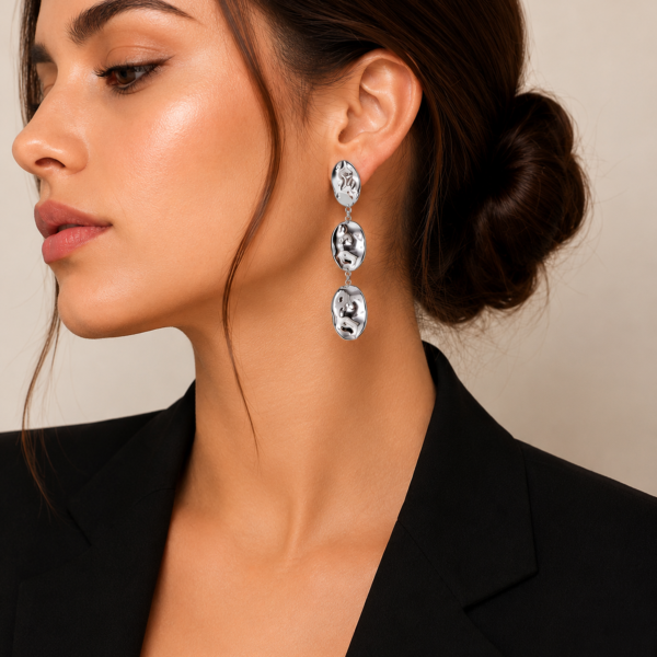 Model wearing modern 16K white gold plated stainless steel drop earrings featuring an organic textured design with a high-polish mirror finish.