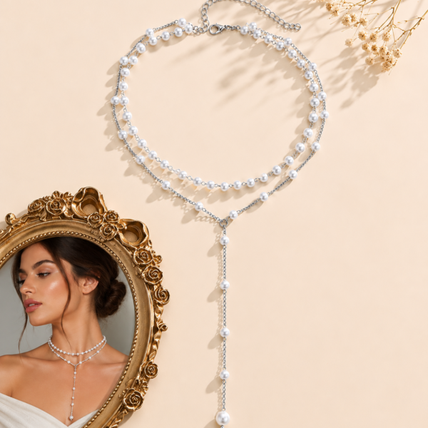 Double-layer faux pearl Y-necklace with silver-tone chain and adjustable clasp displayed on a neutral background.