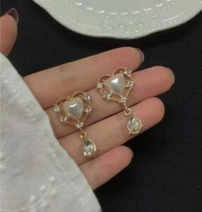 Elegant heart-shaped pearl drop earrings with crystal accents and teardrop pendant for women.