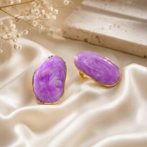 Elegant purple oval gold finish statement stud earrings for women on a luxury satin background.