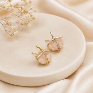Elegant gold-tone floral stud earrings featuring blush pink crystal stones for women.