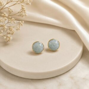 Minimalist gold-tone round stud earrings featuring elegant sky blue marbled stones for women.