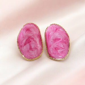 Pink marbled resin statement stud earrings with gold-tone border.